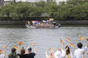 Crowd cheering from the riverside