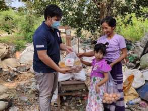 AAR local staff handing the food package