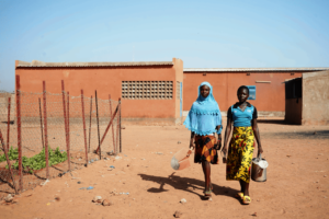 Laeticia & Aminata walk to the school garden