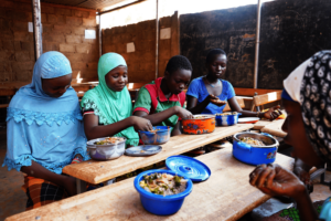 Laeticia & Aminata enjoy a meal with friends
