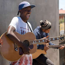 Mitchell plays Rounelle's guitar