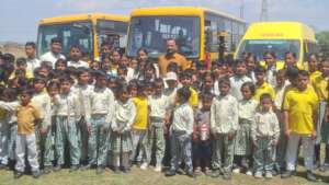 Students in front of our three school busses