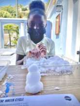 A child builds a snowman with polymer snow