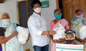 Project Leader distributing urgent food supplies