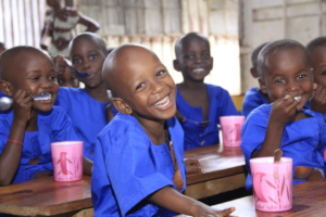 Children eating their daily porridge at school.