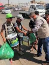 Boys selling water on the streets get food