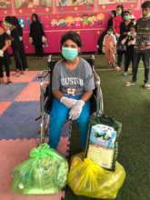 Girl in wheelchair gets food and hygiene packages