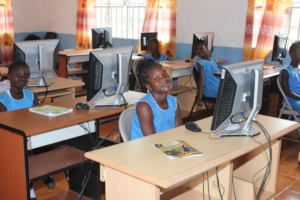 Girls leaning in Raspberry Pi computer lab