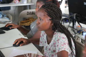 Young lady receiving basic computer training