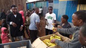 Children being served with fruits.