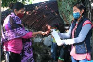 Hand disinfection prior to food distribution.