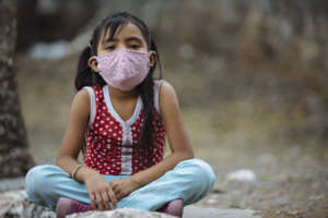 Children and adults receive cloth face masks.