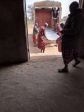 Unloading new metal roof sheets for the school