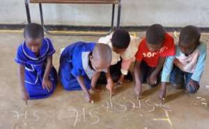 Std1 children learning the word 'sit'