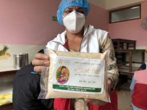 NYF staff holding a packet of Lito