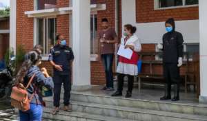 *Nishita (left) arrives at the quarantine center.
