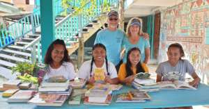 Visitors to OA bring books for the library.