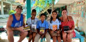 Visitors to OA bring books for the library.