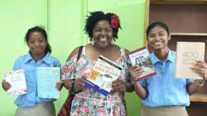 Visitors to OA bring books for the library.