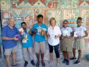 Visitors to OA bring books for the library.