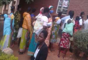 Women receiving face masks and soap