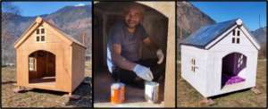 Vet assistant Subash painting a donated dog house
