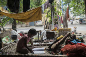 Child studies under a bridge due to school closure
