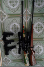 Hunting rifles w/laser scopes and pistols seized