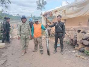 Seized chainsaw (logs & large kiln in background)