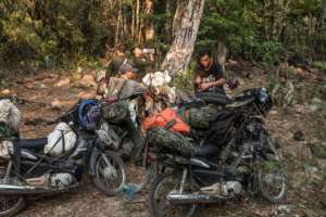 Rangers load up their motorbikes for a long patrol