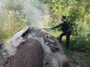 Rangers destroying an illegal charcoal kiln