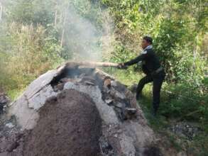 Rangers destroying an illegal charcoal kiln