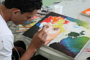 Alex painting his first canvas at OYE.