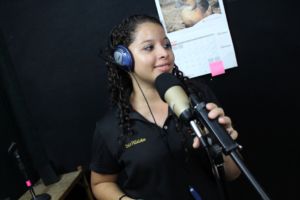 Empowered young woman Ivelis in OYE's radio booth