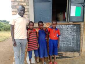 Cosma staff with Nakyanzi and other two at school