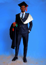 Kenneth clad in his graduation gown