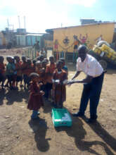 A teacher guiding learners to serve their snacks