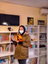 Khatereh picks a book from our library for her son