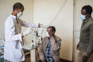 Gebre having his eyesight assessed