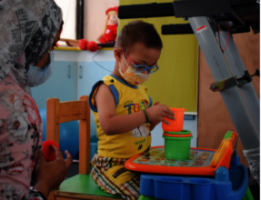 A child immersed in his physical therapy session