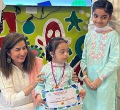 Girl with certificate on ECI Milestone Celebration