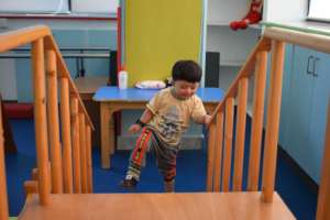 Child practicing climbing during physical therapy