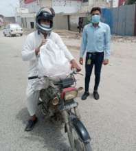 A caretaker being given grocery bag