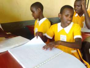 A child at Salama School for the blind reading.