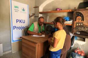 Dr Muhammad with a PKU child