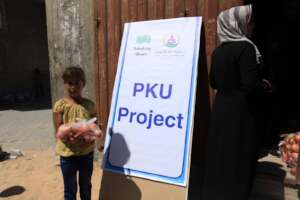 A PKU child holding a bag she received