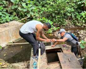 Nava (left) collects water sample