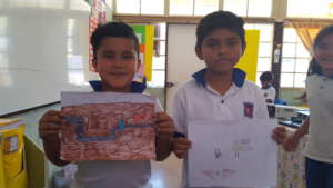 Children showing their drawing on family experienc