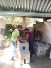 TRL's outreach team installing a ONIL stove