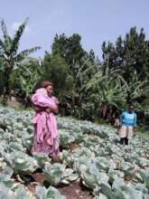 Young mother gardener, baby and brother